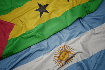 waving colorful flag of argentina and national flag of sao tome and principe .