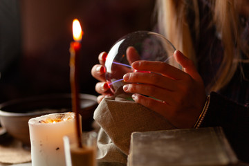 Seer with magic ball performs ritual. Psychic vision, fortune teller.