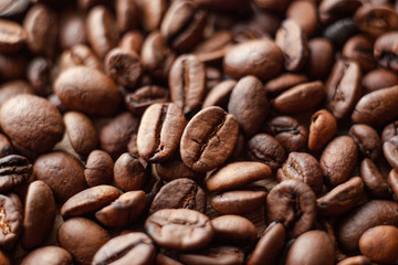 Selective focus on roasted brown coffee beans, can be used as a background and texture. Coffee beans on the table background texture. Background full of coffe beans studio shoot.