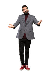 Handsome man with glasses presenting and inviting to come with hand over isolated white background