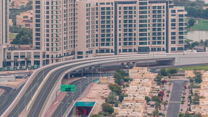 Obraz na płótnie Canvas Aerial view of apartment houses and villas in Dubai city timelapse, United Arab Emirates
