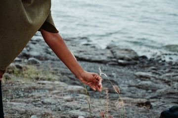 Girl picking flower in natural background.