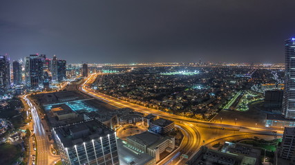 Obraz premium Jumeirah Lake Towers residential district aerial night timelapse near Dubai Marina