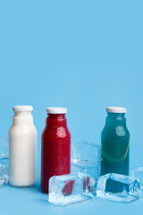 Close up of three different types detox drinks on blue