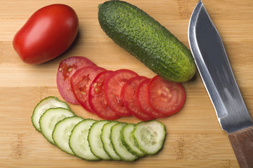 Salad. Cooking vegetable salad. Salad of tomatoes and cucumbers. Tomatoes and cucumbers.