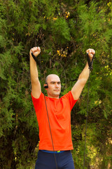 Obraz premium Exercise in park and listen music, close up