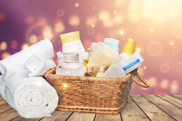 Bath towel and basket with accessories for spa on blur background