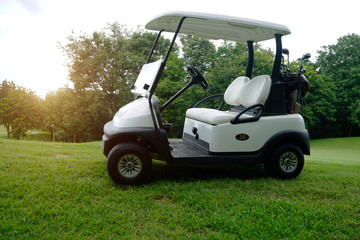 Golfcar in beautiful golf course in the evening golf course with sunshine