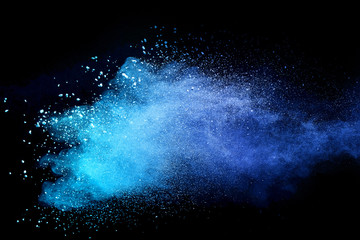 Blue sky color powder explosion on black background.