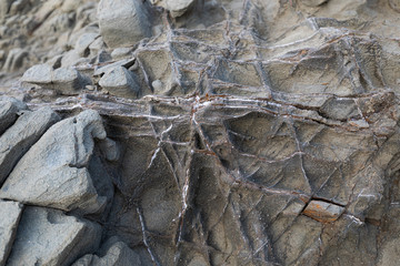 Natural volcanic stone texture. Rock texture with metal elements (Selective focus)