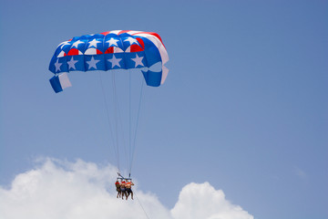 American flag colors parasail wing against cloudy blue sky, Punta Cana, Dominican Republic