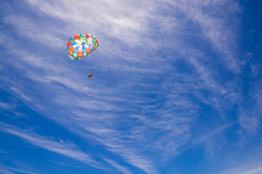 Colorful parasail wing against cloudy blue sky, Punta Cana, Dominican Republic
