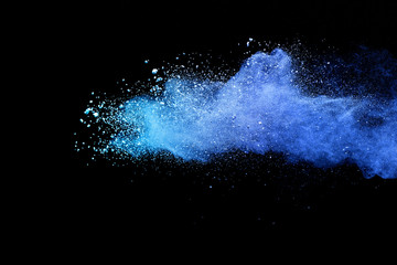 Blue sky color powder explosion on black background.