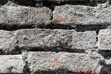 Brick wall with cracked stones, 