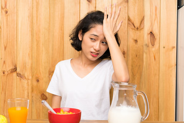 Asian young woman having breakfast milk having doubts with confuse face expression