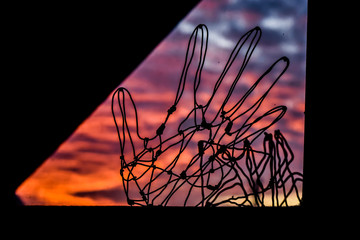 Fototapeta na wymiar Wire hand. Sunset in the background