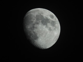 the moon is a celestial body, a satellite of the Earth, glowing with reflected sunlight.