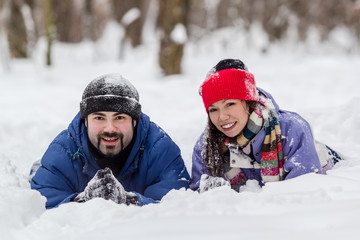 Fototapeta na wymiar Boy and girl having fun in snow at winter