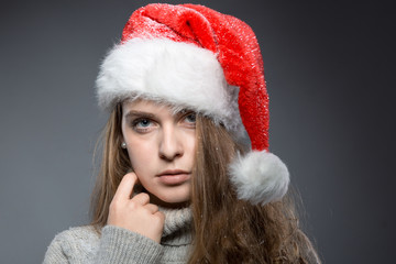 christmas girl with santa claus hat in a turtleneck