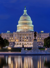 Obraz premium The Capitol - A dusk view of west side of U.S. Capitol Building, with Ulysses S. Grant Memorial and Reflecting Pool at front, Washington, D.C., USA. No recognizable trademark or person in the image.