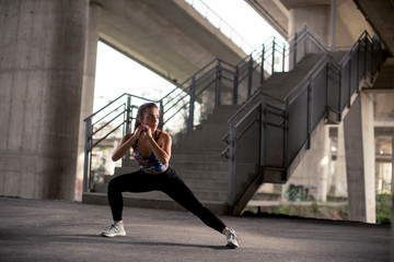 Fototapeta na wymiar Young woman exercise in urban environment
