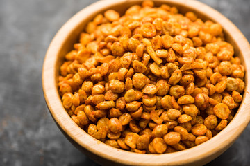 Fried and Spicy Chana Dal Masala is a popular Chakna recipe. served in a bowl. selective focus