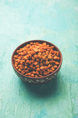 Fried and Spicy Chana Dal Masala is a popular Chakna recipe. served in a bowl. selective focus