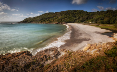 Crashing waves at Pwll Du Bay on the Gower peninsula in Swansea, South Wales, UK, once an extensive limestone quarry and also a popular smuggling cove.