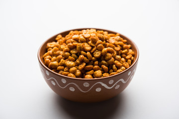 Fried and Spicy Chana Dal Masala is a popular Chakna recipe. served in a bowl. selective focus