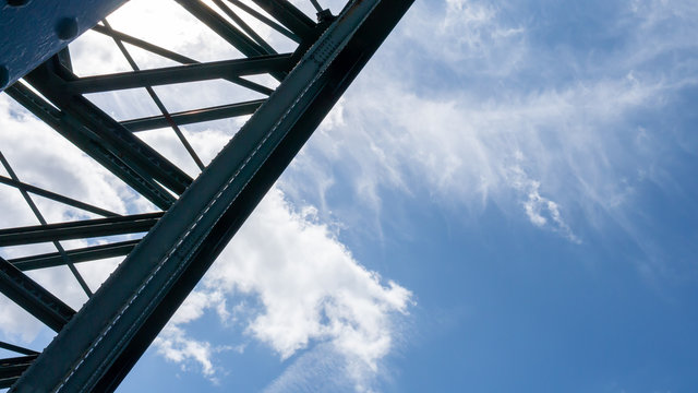 Abstract close up of the steel structure of the Tyne Bridge in Newcastle silhouetted against a beautiful summer sky.