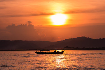 Naklejka na ściany i meble Sunset on the Irrawaddy River (Ayeyarwaddy River) in Bagan, Myanmar (Burma)