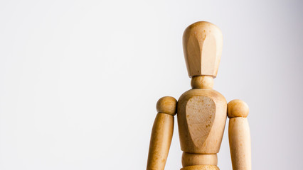 Generic pose of a wooden artist mannequin isolated against a beautifully graduated white to grey background.
