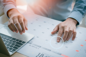 businessman working on laptop in office, business man with planing calendar. business management event organization.