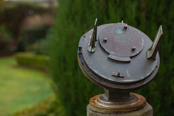 Fototapeta premium close-up vintage ancient metal rusty sundial in the garden