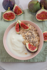 Oat granola with nuts, yogurt, honey, fresh figs and blueberries