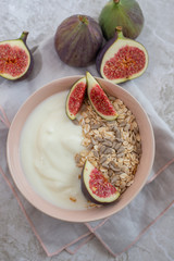 Oat granola with nuts, yogurt, honey, fresh figs and blueberries