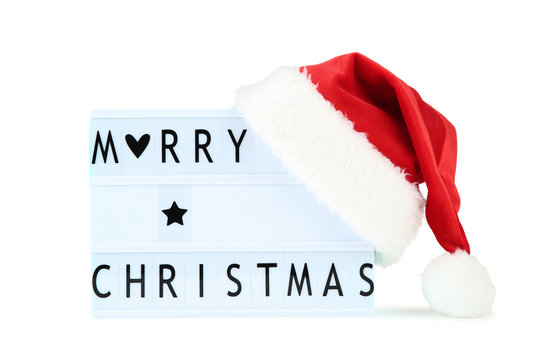 Lightbox with words Merry Christmas and red santa hat on white background - Powered by Adobe