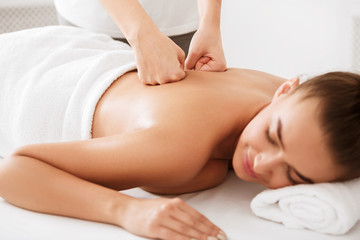 Fototapeta na wymiar Body treatment. Girl getting back massage from physiotherapist