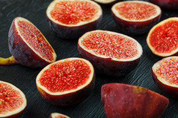 Ripe Figs. Creative diagram of chopped figs on a black textural background in the form of a texture inscribed in a rectangle