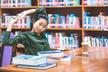 Asian schoolchildren are tired of studying hard and stretching. At the university library, Back to school concept
