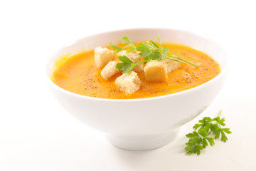 bowl of soup with crouton and parsley on white background