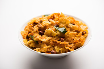 Cornflake Chivda or Corn Chiwda loaded with peanuts and Cashew. Served in a bowl. selective focus