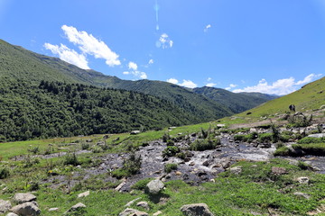 Landscape views of the Caucasus Mountains, river and villages. Peak and river Enguri. Georgia. Summer. 2019