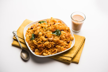Cornflake Chivda or Corn Chiwda loaded with peanuts and Cashew. Served in a bowl. selective focus