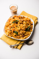 Cornflake Chivda or Corn Chiwda loaded with peanuts and Cashew. Served in a bowl. selective focus