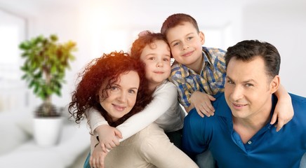 Young family at home smiling at camera