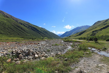 Landscape views of the Caucasus Mountains, river and villages. Peak and river Enguri. Georgia. Summer. 2019