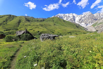 Landscape views of the Caucasus Mountains, river and villages. Peak and river Enguri. Georgia. Summer. 2019