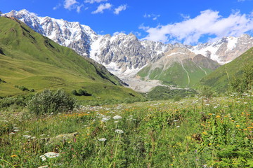 Landscape views of the Caucasus Mountains, river and villages. Peak and river Enguri. Georgia. Summer. 2019