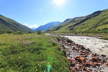Landscape views of the Caucasus Mountains, river and villages. Peak and river Enguri. Georgia. Summer. 2019